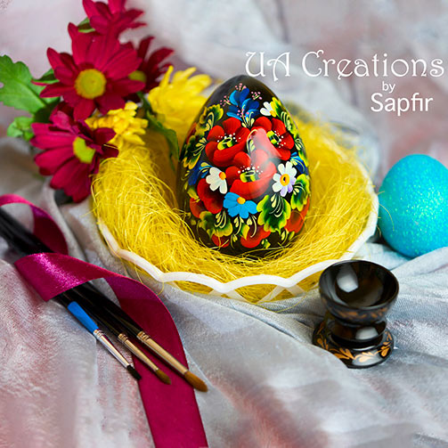 Hand Painted Easter Egg on a decorative nest with flowers